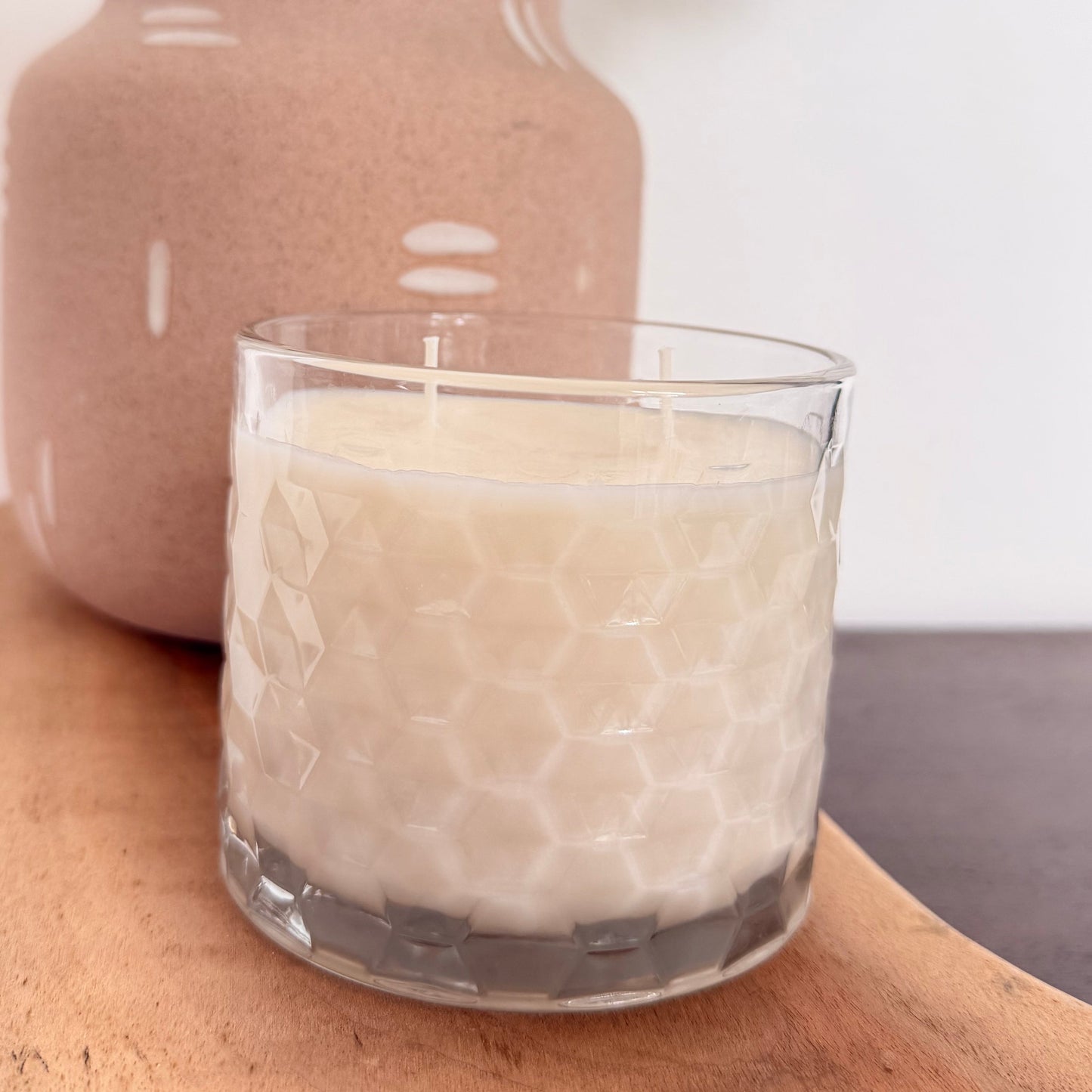A clear glass Lavender Bloom candle with a textured honeycomb pattern.